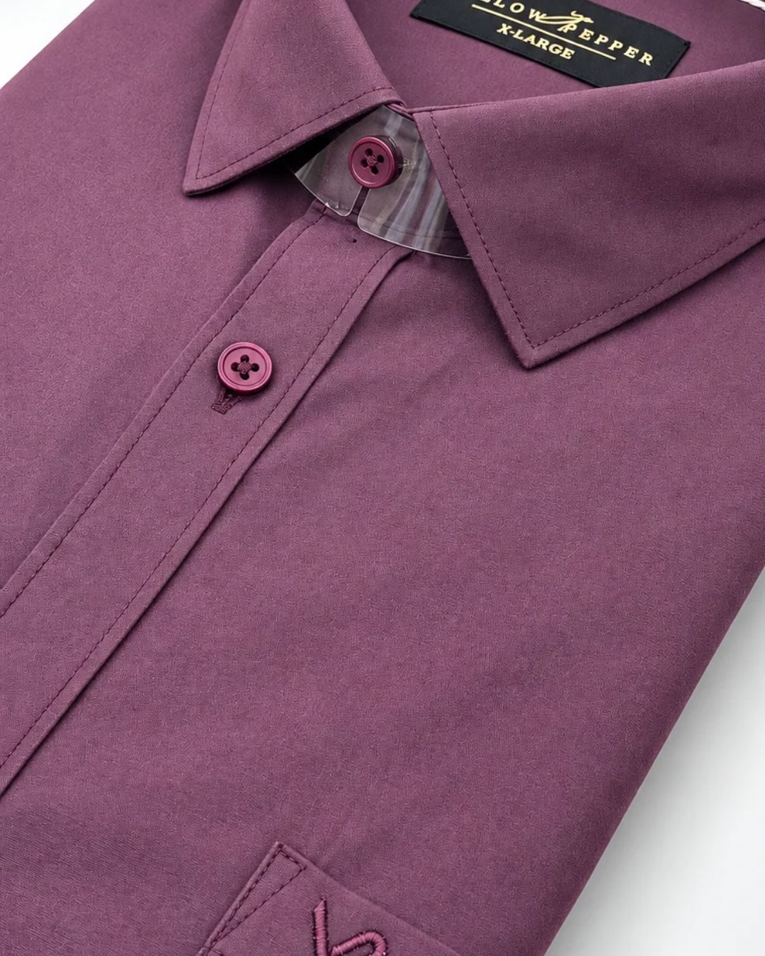 A close-up of a folded purple dress shirt with a pointed collar, matching buttons, and a visible neck label reading 'LOW ZEPPEFF 3 LARGE'.