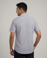 Man wearing a striped shirt against a plain background