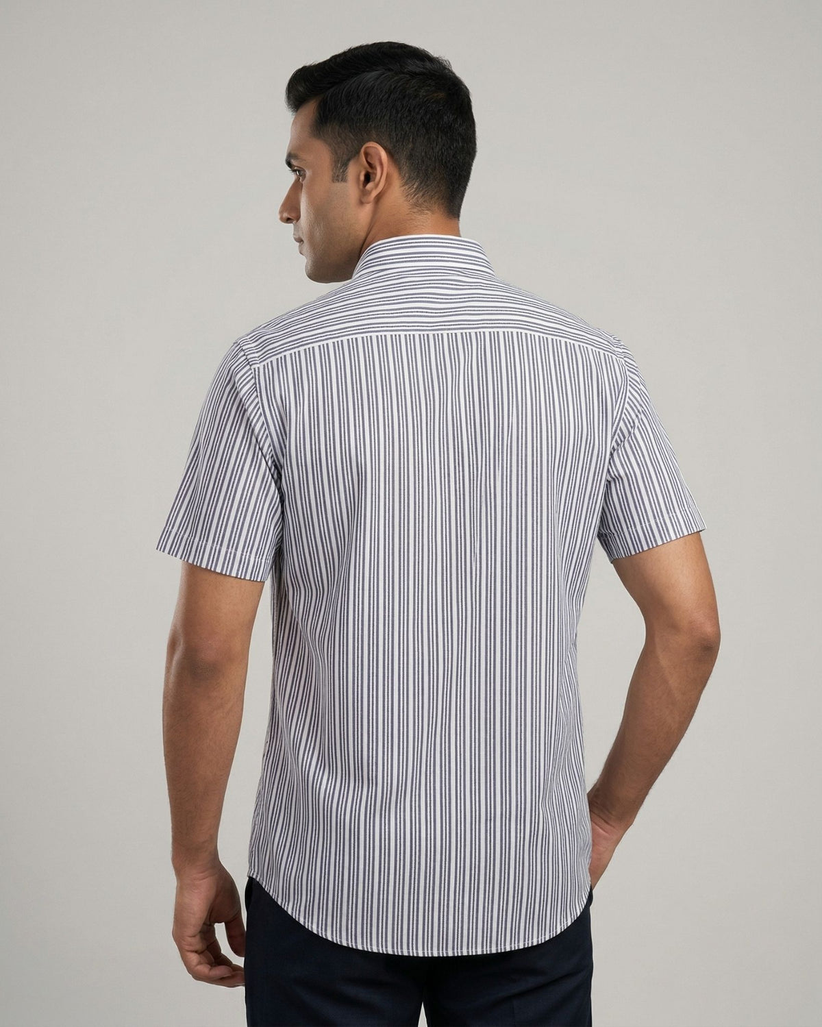 Man wearing a striped shirt against a plain background