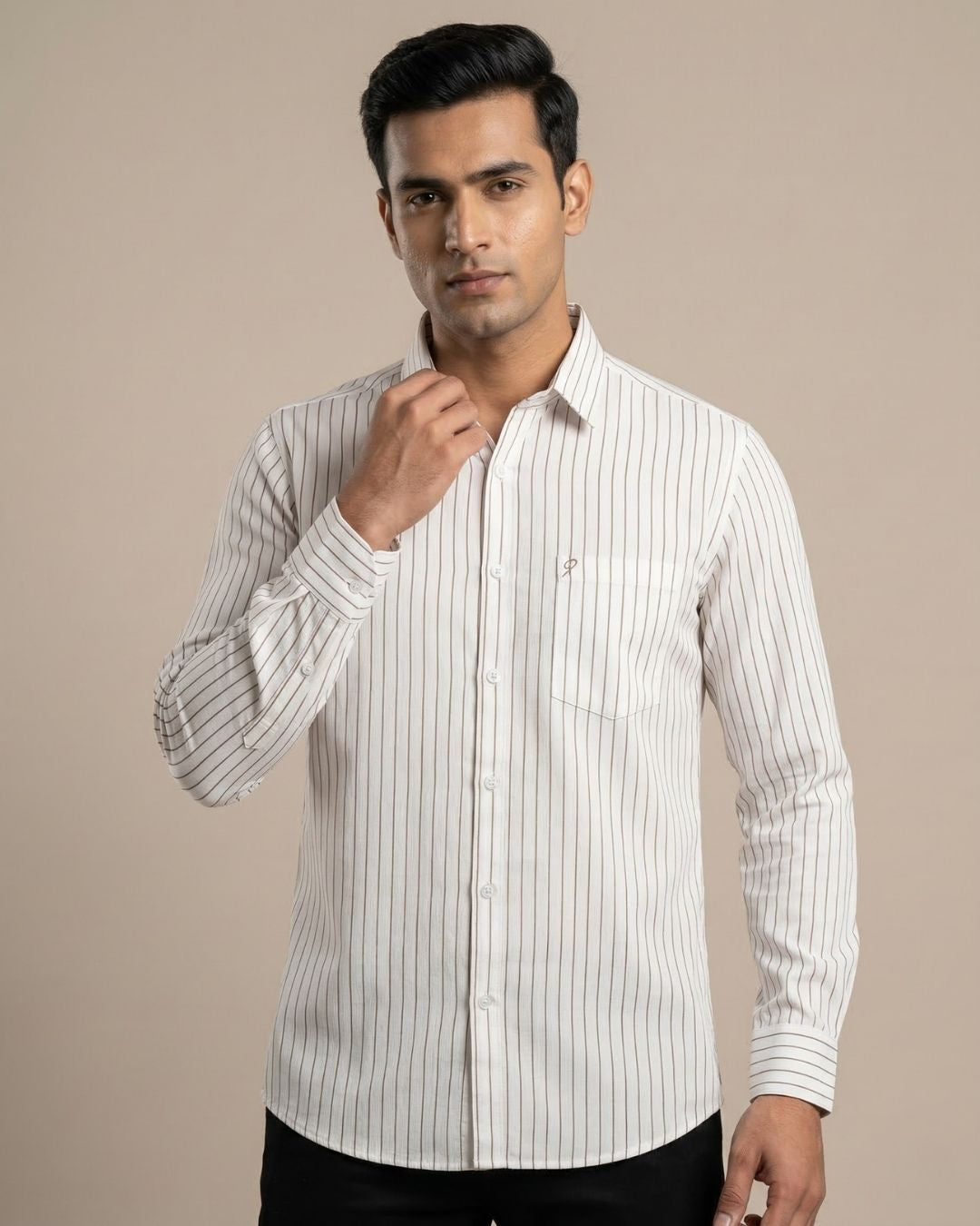 Man wearing a white shirt with black stripes against a beige background