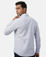 Man wearing a light blue striped shirt against a white background
