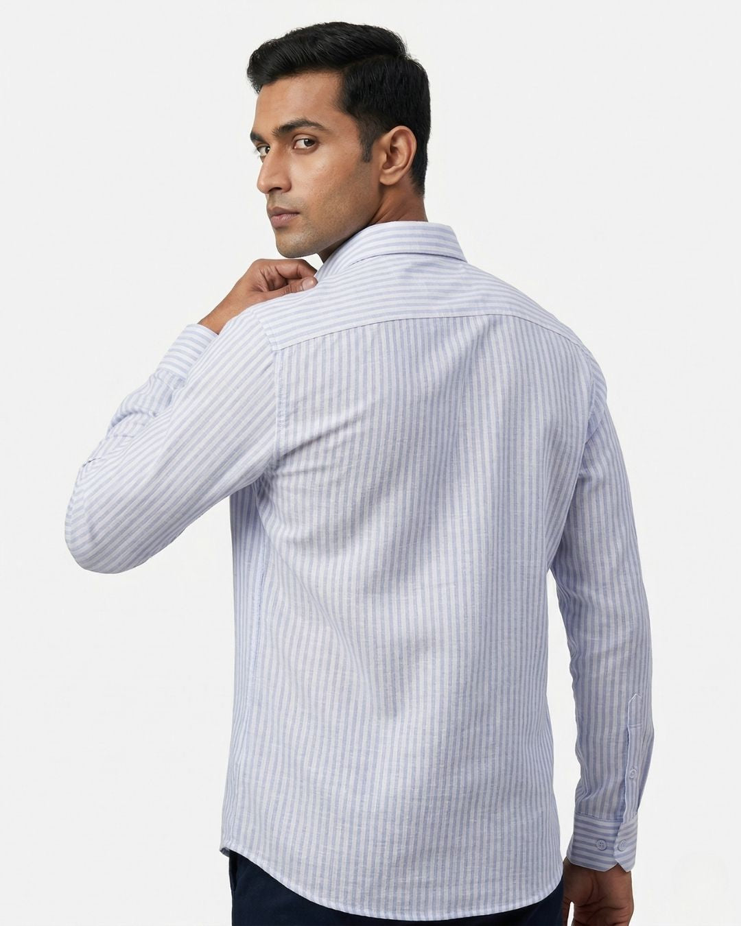 Man wearing a light blue striped shirt against a white background