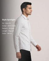 Man wearing a white striped shirt with style details on a light gray background