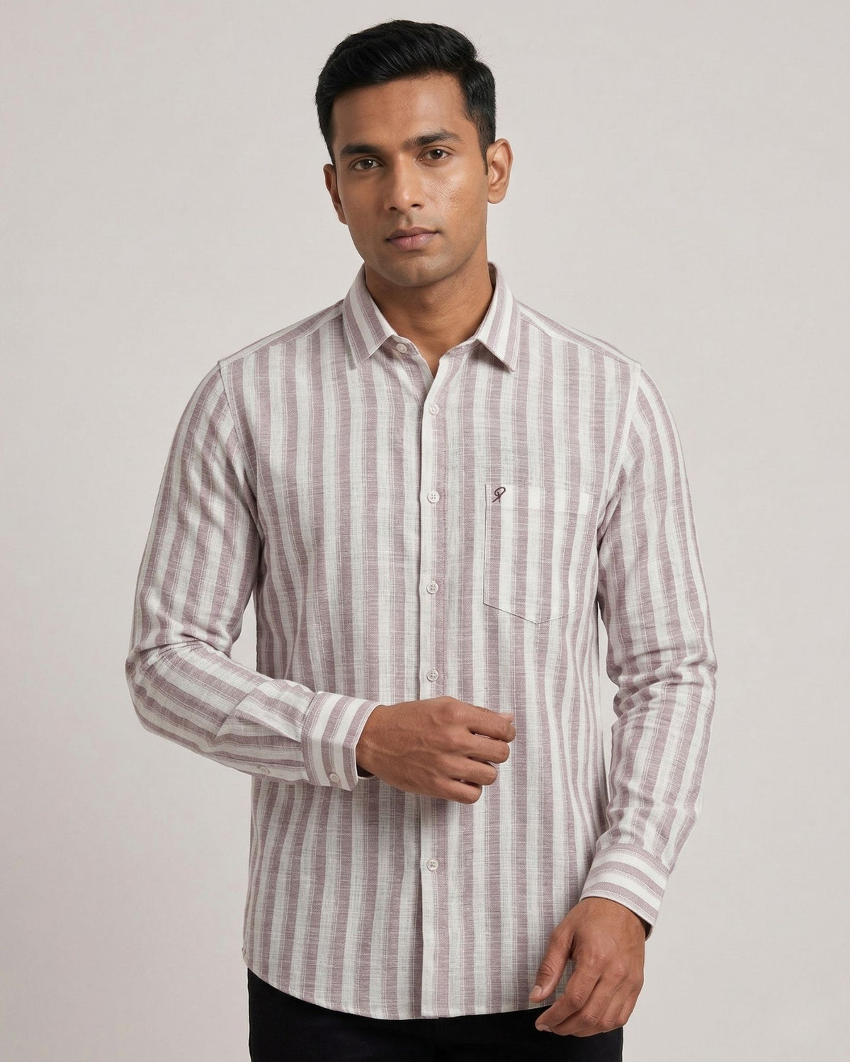 Man wearing a striped shirt against a plain background