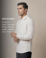 Man wearing a white striped shirt against a beige background