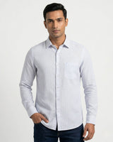 Man wearing a white and gray striped shirt on a white background