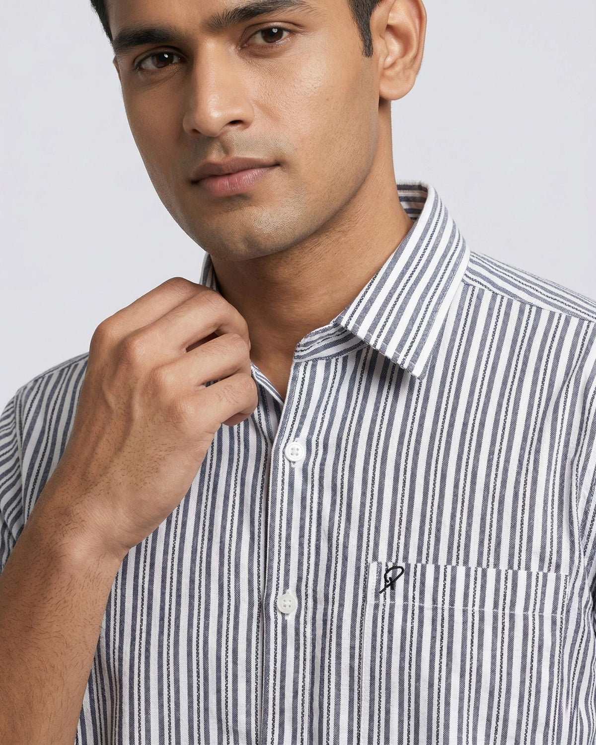 Man wearing a striped shirt against a plain background