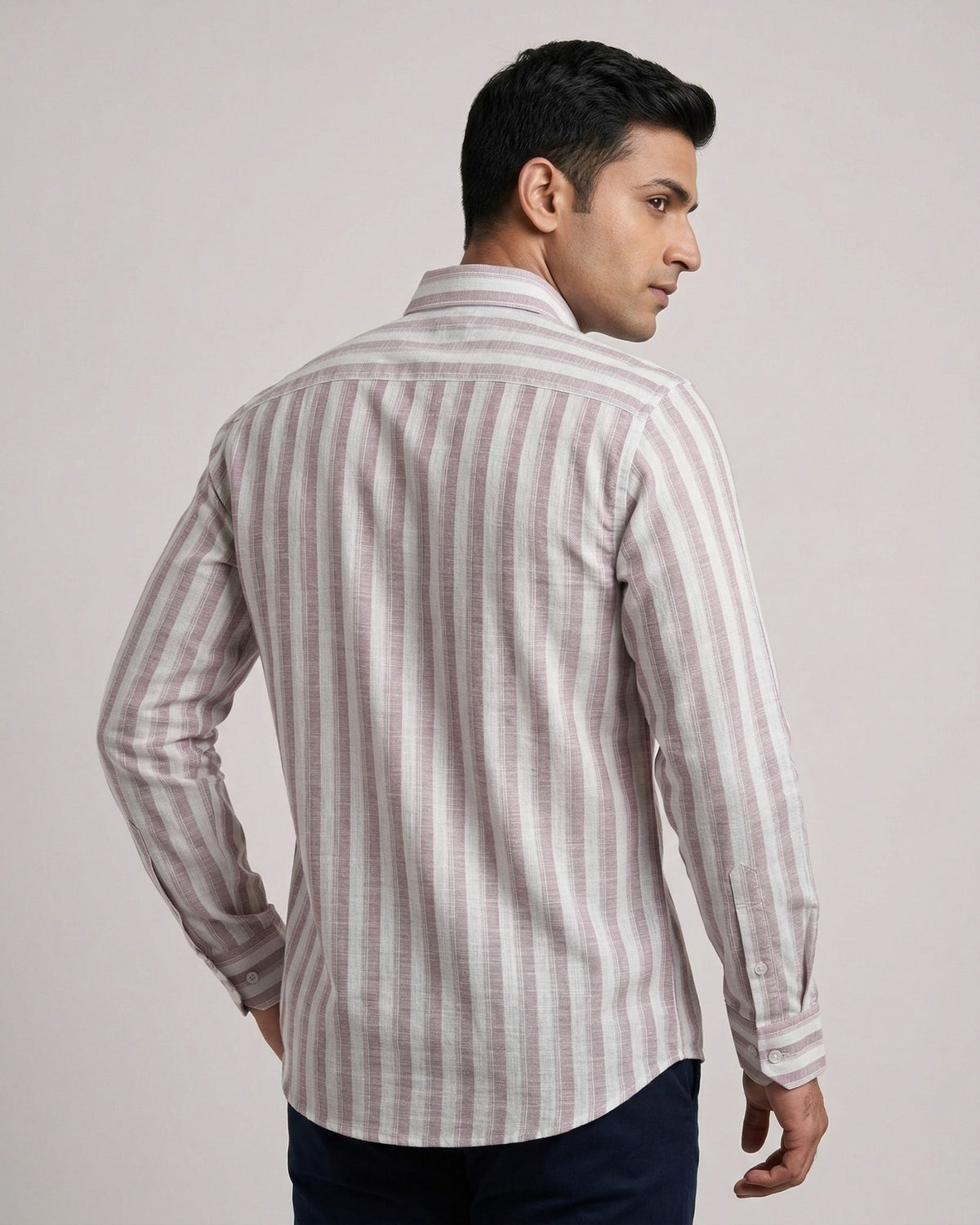 Man wearing a striped shirt against a plain background