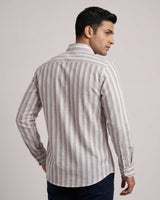 Man wearing a striped shirt against a plain background