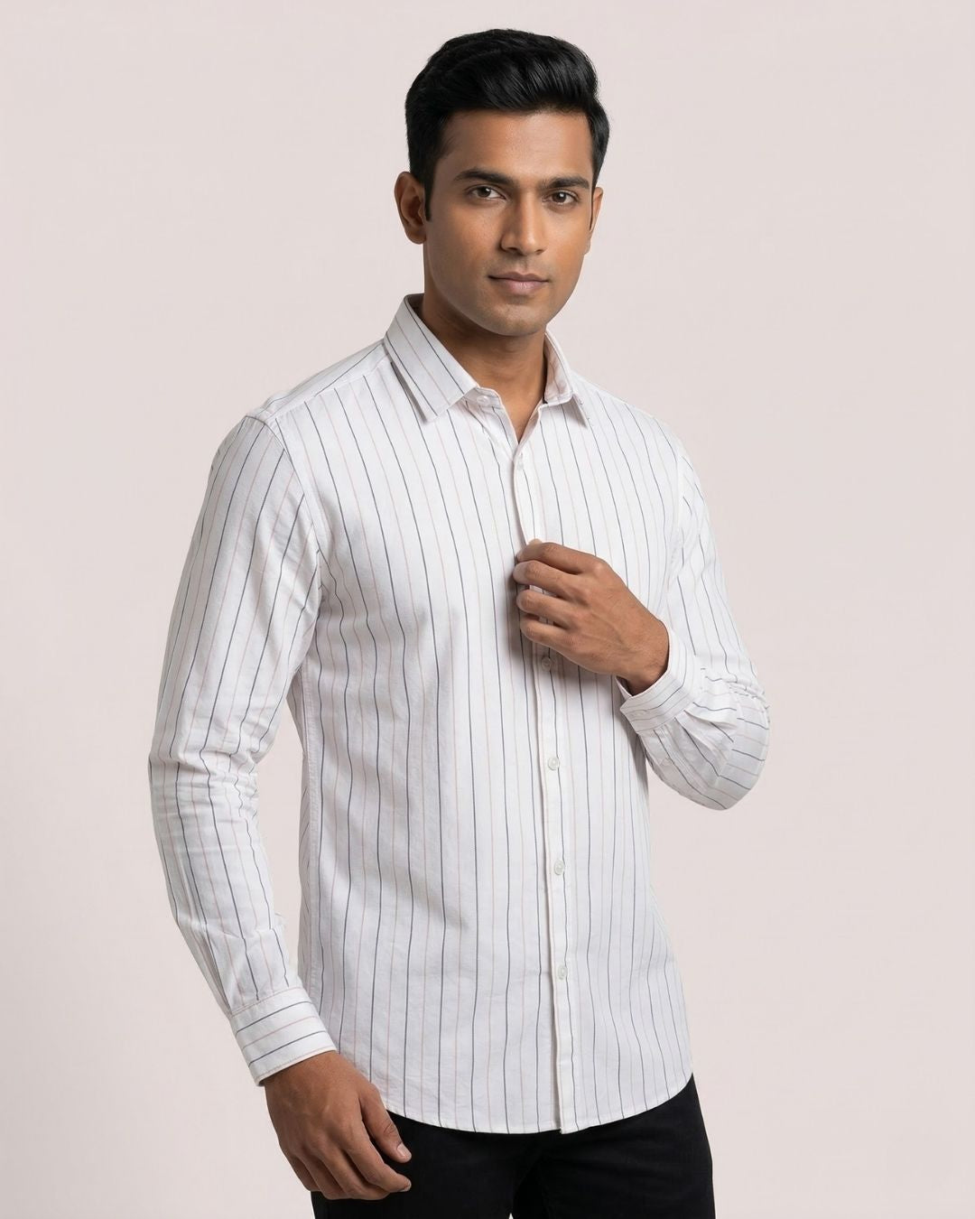 Man wearing a white striped shirt against a light pink background