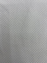 A close-up of a light gray textured fabric with a repeating geometric pattern.