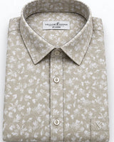 A folded long-sleeve button-up shirt by YellowFrepper, featuring a light beige and white floral pattern, a classic collar, and a button-down front.